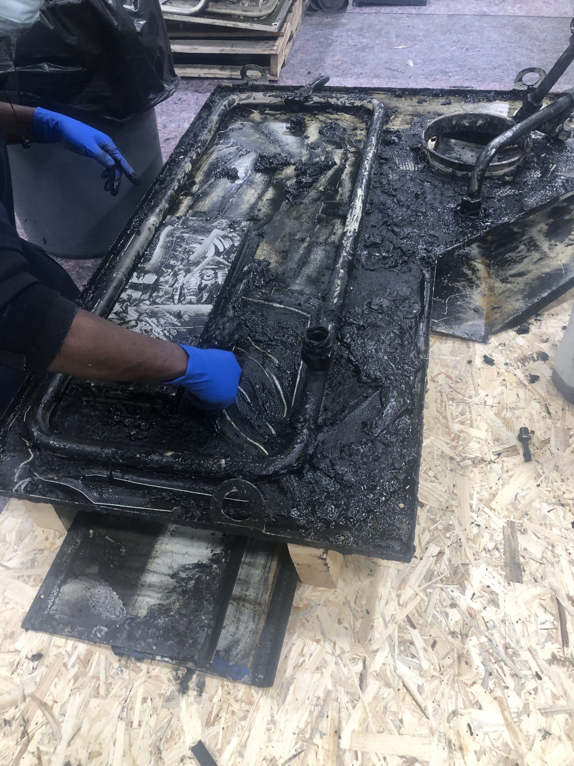 Machine during the process of being cleaned grease and grime inside of the machine being removed